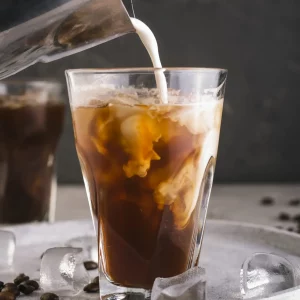 milk-pouring-into-glass-with-coffee